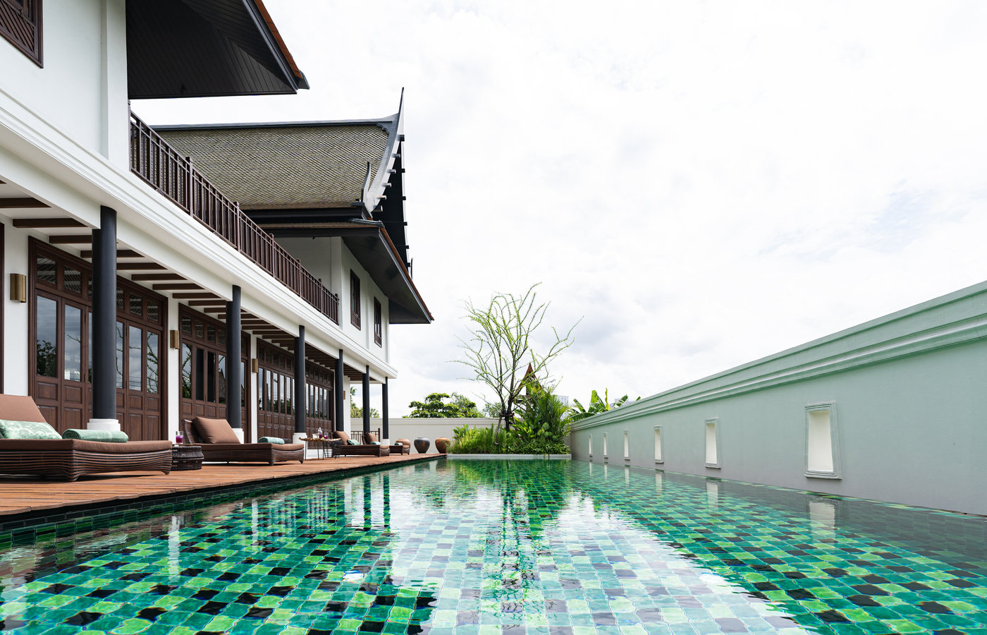The green-tiled lap pool at Siri Sala, running along the garden wall